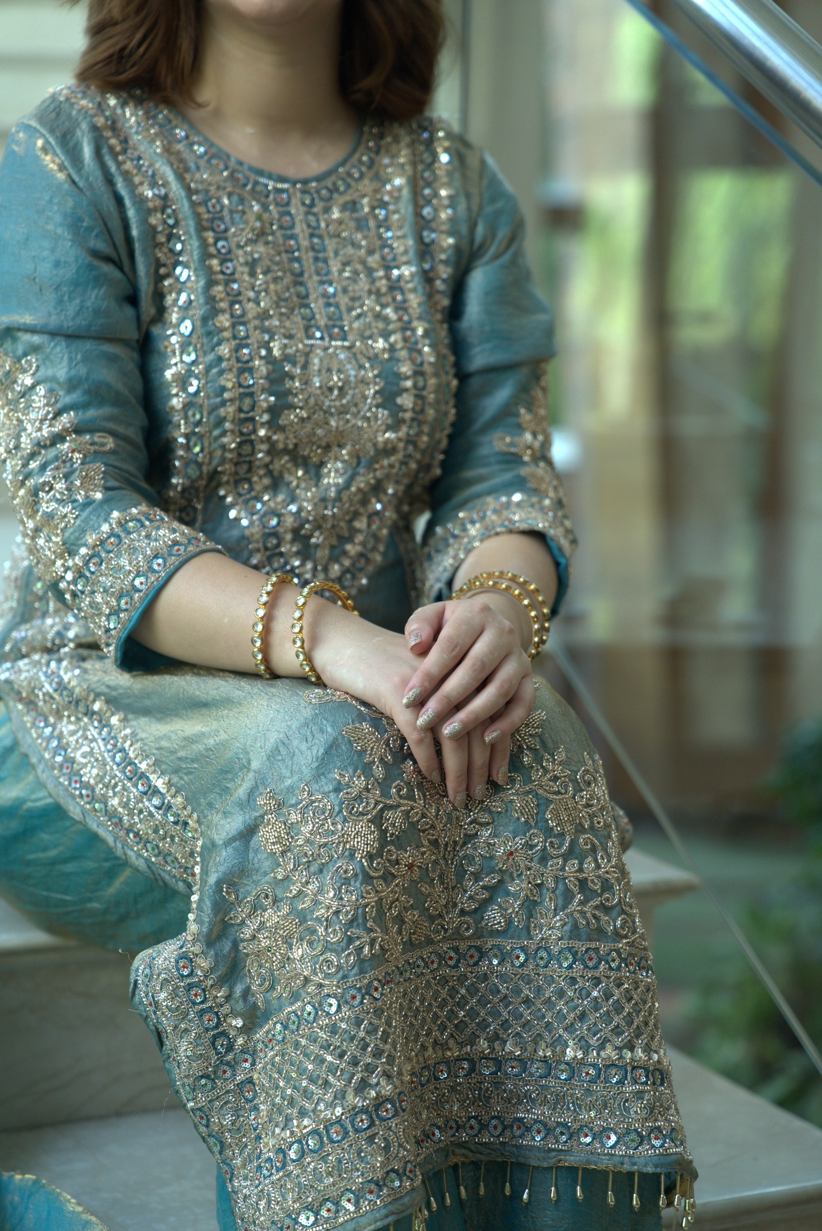 A close-up of the blue suit showing the embroidered sleeve and front