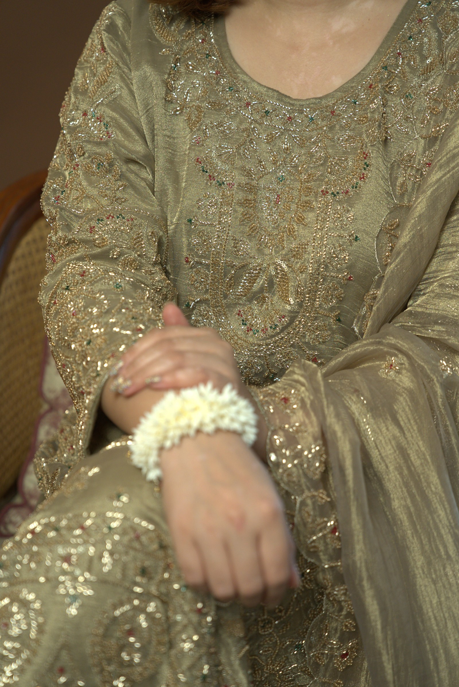 Olive-gold sleeve and neckline details with repeating embroidered motifs