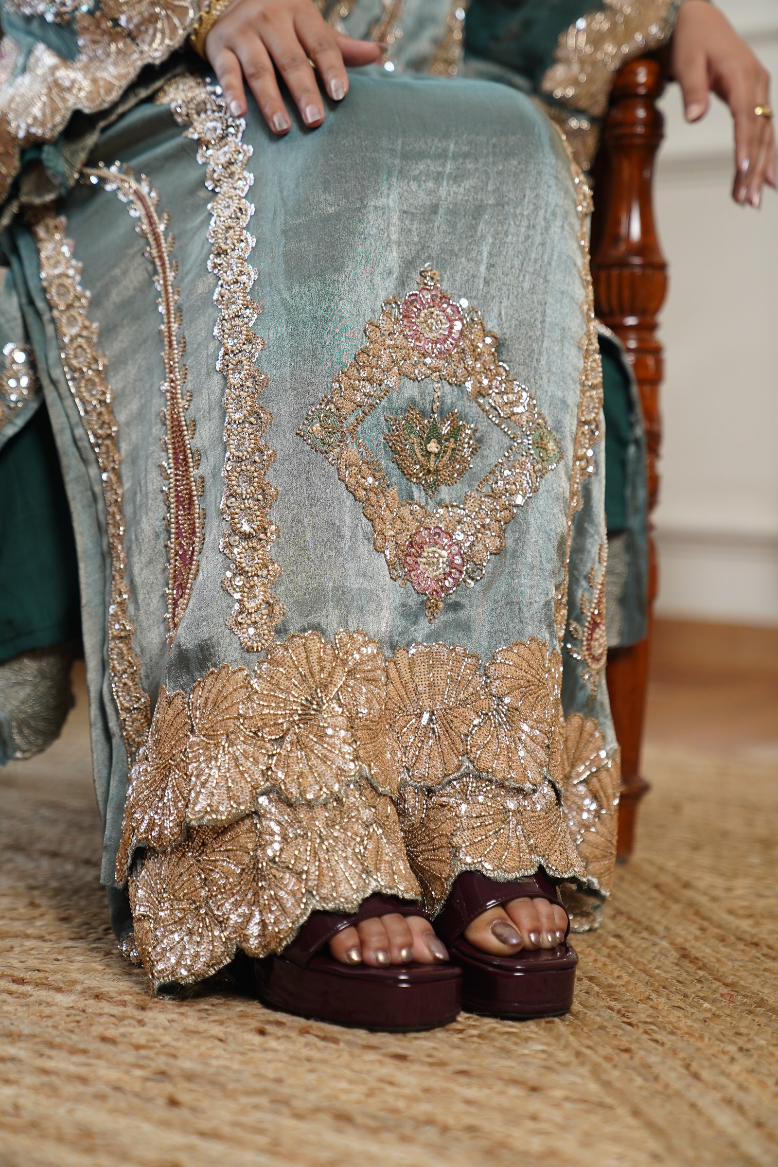 A closer view of the same sage-teal suit, showing the diamond motif and wide scalloped hem