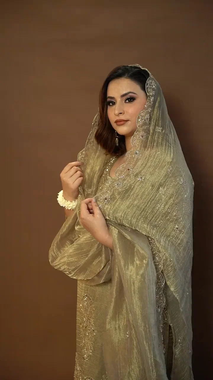 Olive-gold suit with the sheer dupatta draped over the head